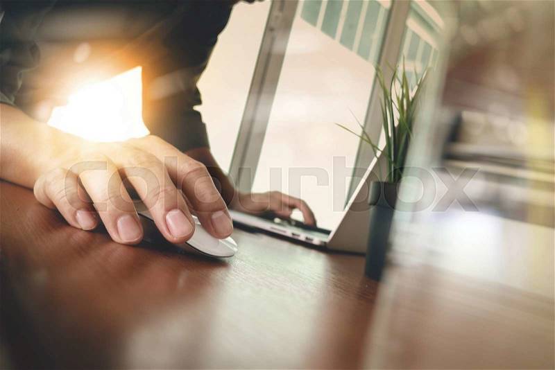 Businessman hand working with modern technology and glass of water as business strategy concept , stock photo