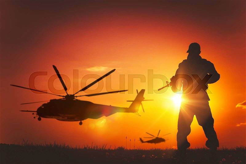 Military Mission at Sunset. Marines Helicopters Air Mission. Soldier with Assault Rifle Cover the Area, stock photo