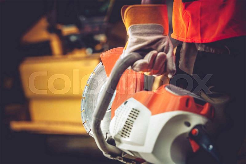 Stone Cutter Works. Construction Worker with heavy Duty Cutter. , stock photo