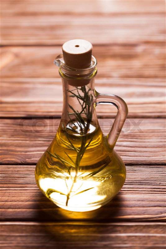 Oil with rosemary branch on the table, stock photo