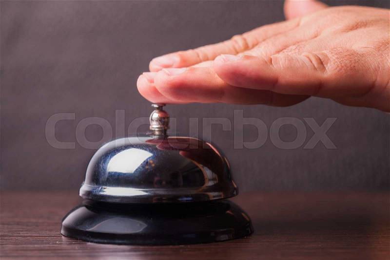 Close-up finger that presses of the service bell ring, stock photo
