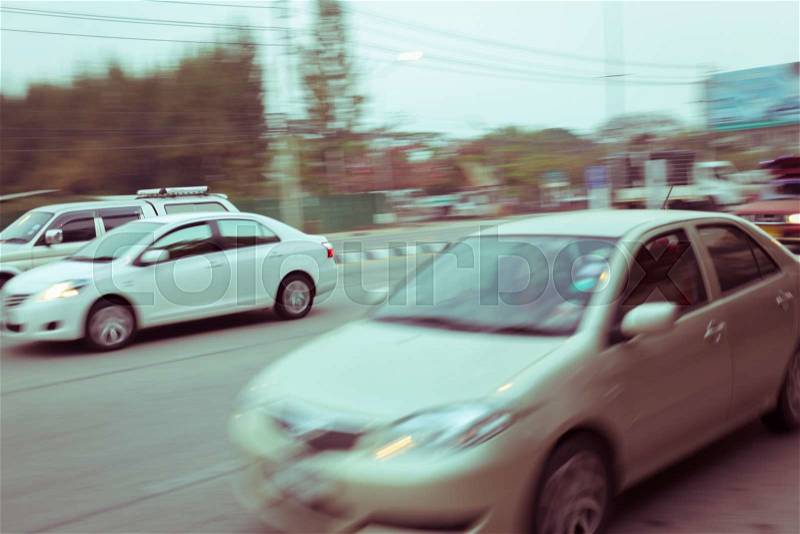 Car driving on road with traffic jam in the city, abstract blurred background, stock photo