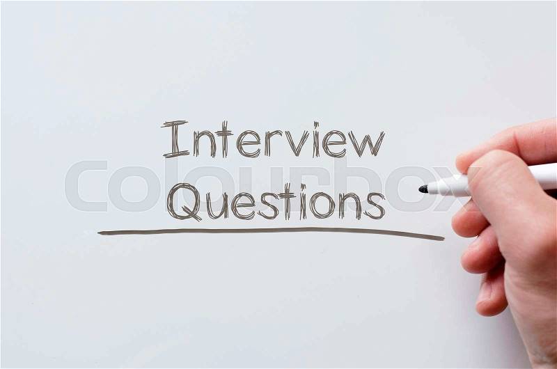 Human hand writing interview questions on whiteboard, stock photo