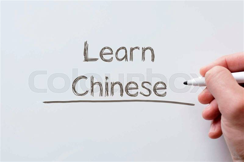 Human hand writing learn chinese on whiteboard, stock photo