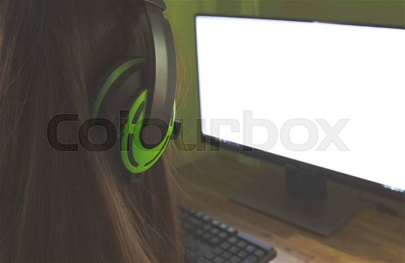 Students working in computer class wearing headphones in college, stock photo