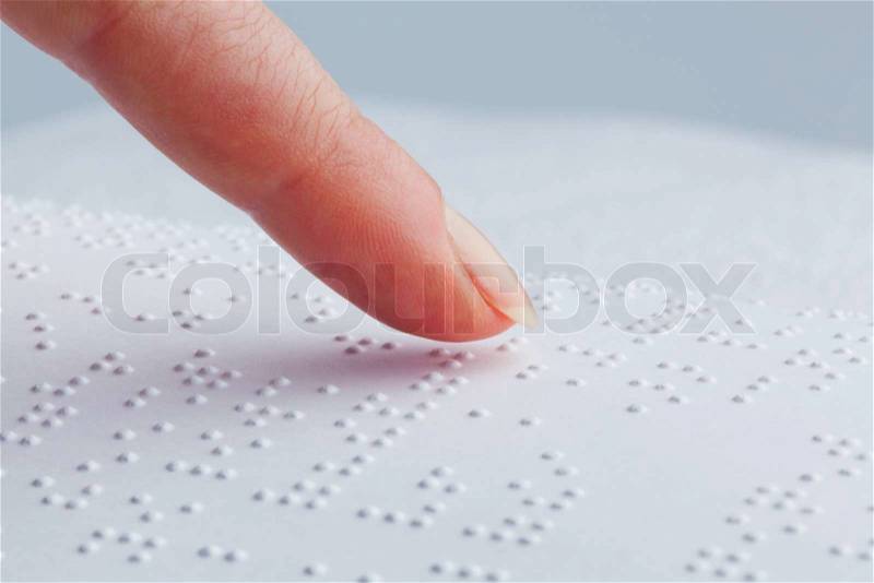 Fingers and Braille. Blind people read a book in Braille, stock photo