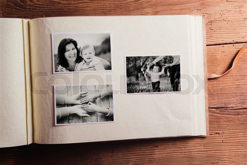Mothers day composition. Photo album, black-and-white pictures. Studio shot on wooden background, stock photo