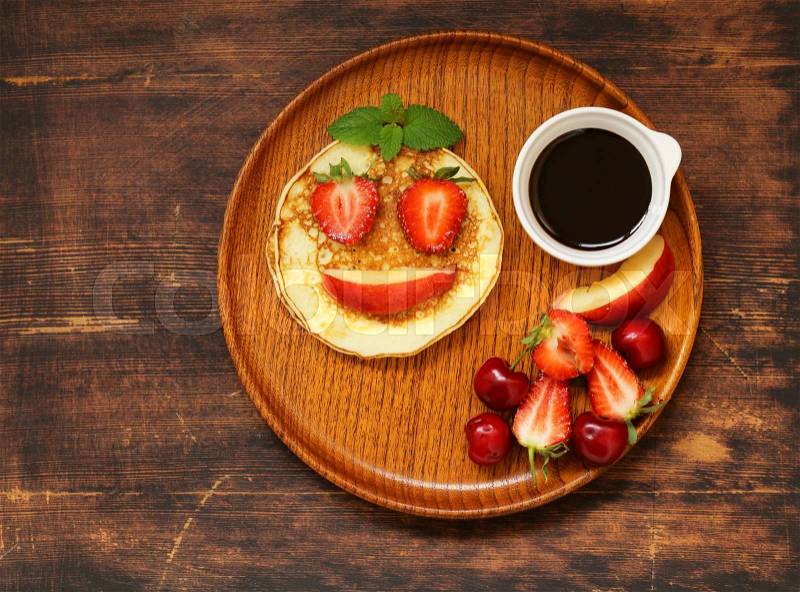 Breakfast pancakes with berries (strawberry, cherry, banana), funny face, stock photo