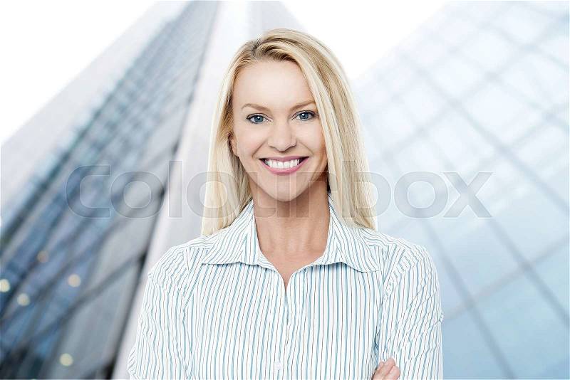 Successful businesswoman in front office building, stock photo