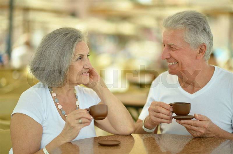 Portrait of a senior couple drinking coffee, stock photo