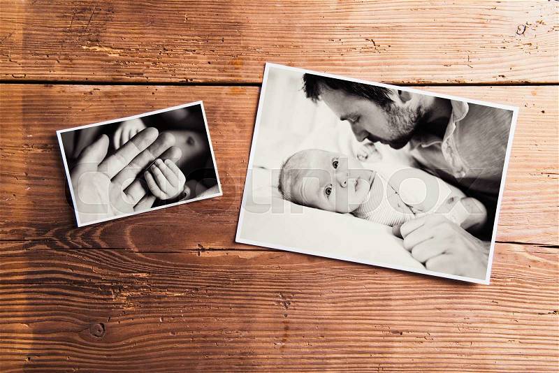 Fathers day composition. Black-and-white family pictures. Studio shot on wooden background, stock photo