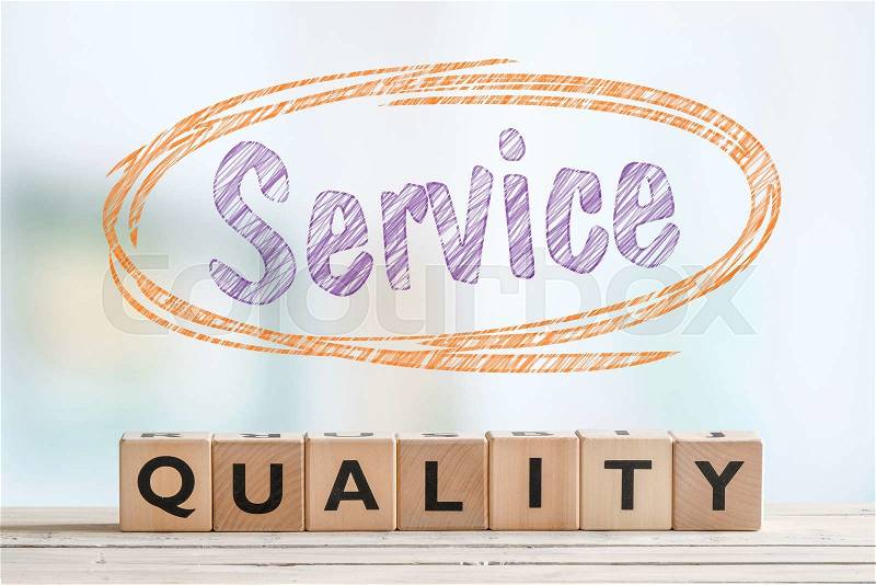 Service quality sign with wooden blocks in a bright room, stock photo
