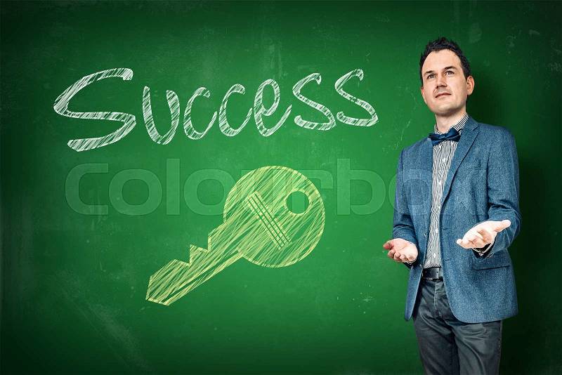 Success coaching with a key on a chalkboard, stock photo