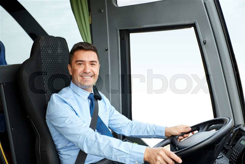 Transport, tourism, road trip and people concept - happy driver driving intercity bus, stock photo