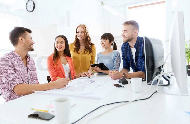 Business, startup, education and people concept - happy creative architect team or students with blueprint working at office, stock photo
