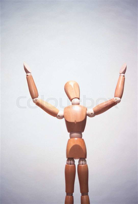 Wooden artists mannequin with hands in air, concept photography, stock photo