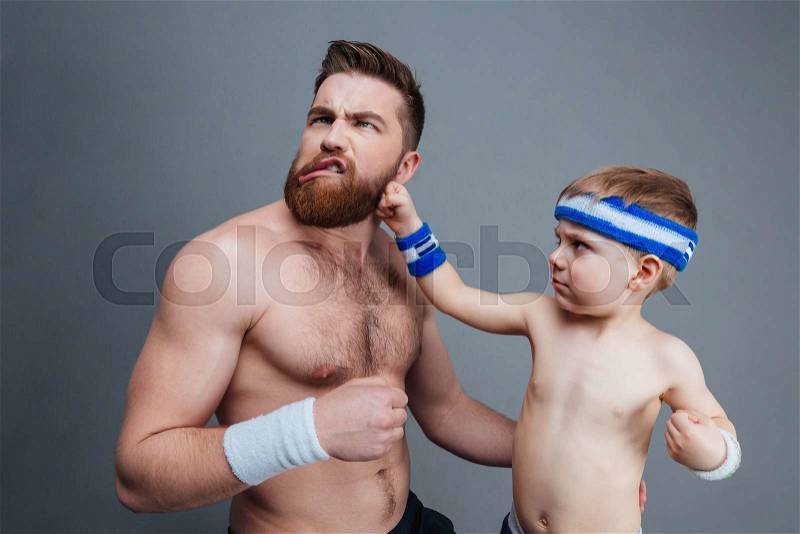 Funny bearded dad and son playing and fighting, stock photo