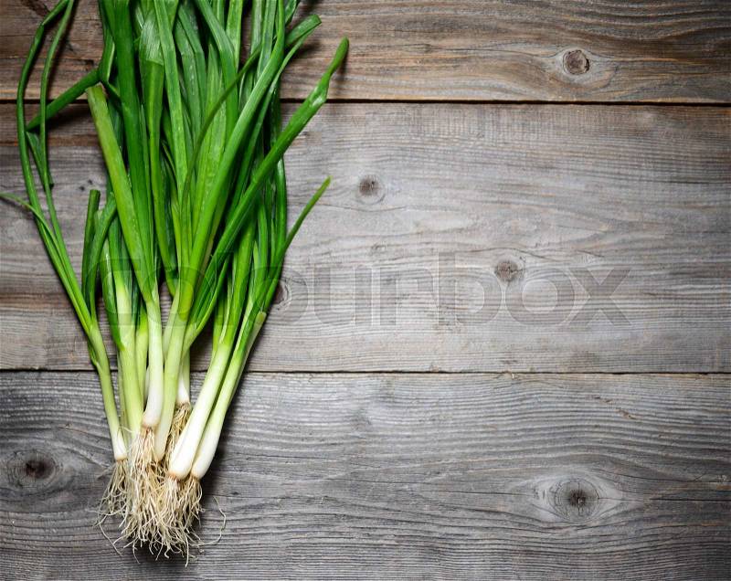 Fresh spring onion on wooden background, stock photo