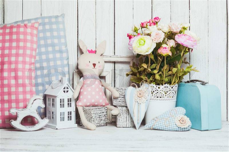 Small toy house, pony, toy bunny, pillows in the children\'s room on wooden background, stock photo