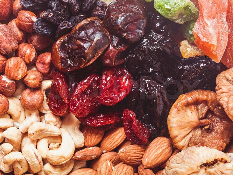Dry fruits and nuts background - close up healthy sweets, stock photo