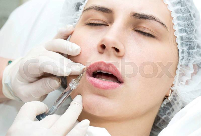 Young girl in a clinic contour lips procedure, stock photo