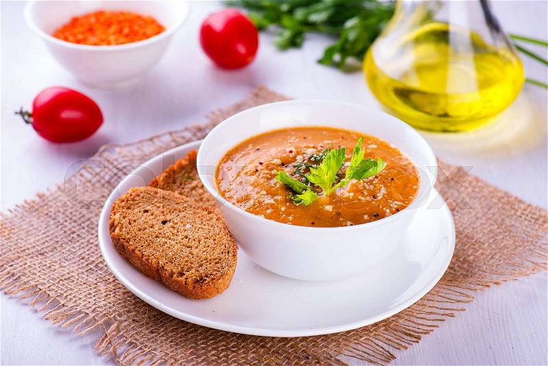 Delicious lentil cream-soup with vegetables and toast, stock photo