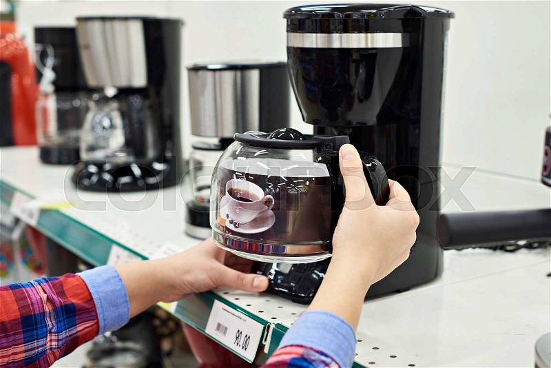 Buyer chooses the coffee machine in the store, stock photo