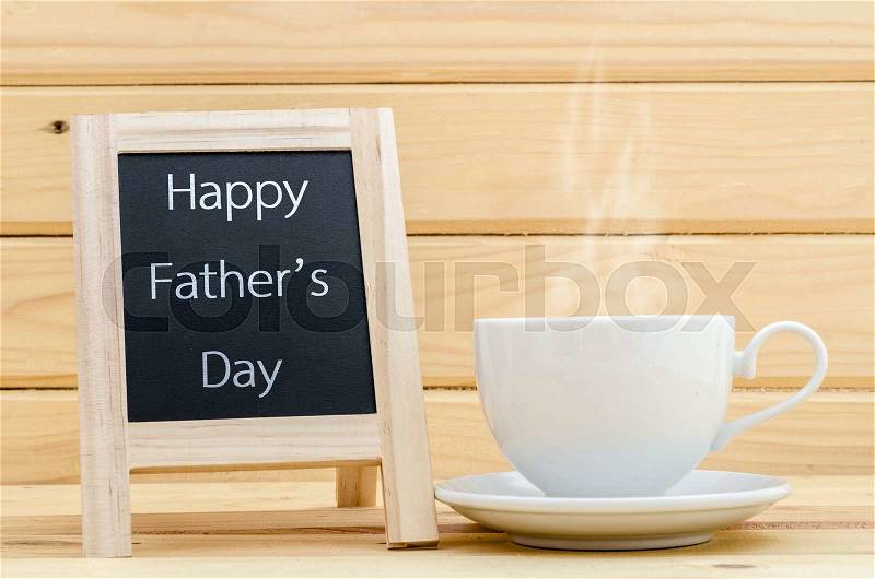 Happy father\'s day in chalkboard with a cup of coffee in wooden room, stock photo