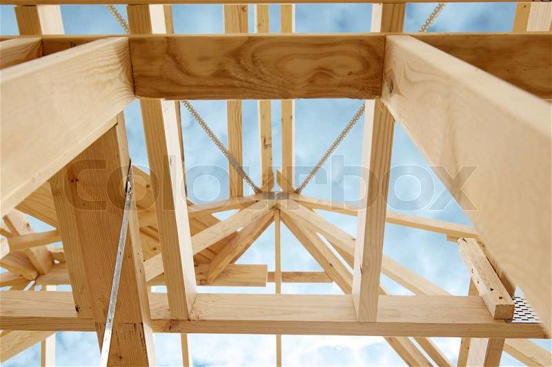 New residential construction home framing against a blue sky.Shallow focus, stock photo