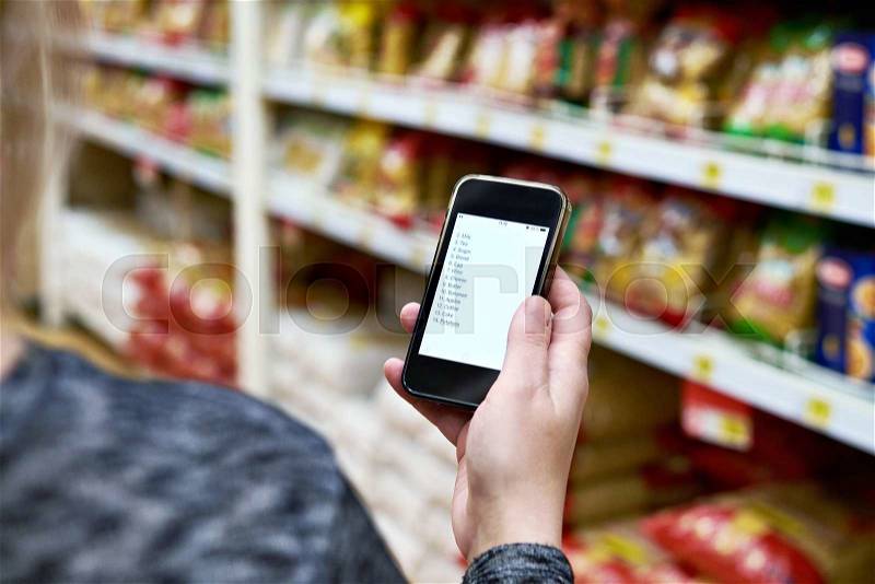 Shopping list on smartphone screen in the hand of women customers, stock photo