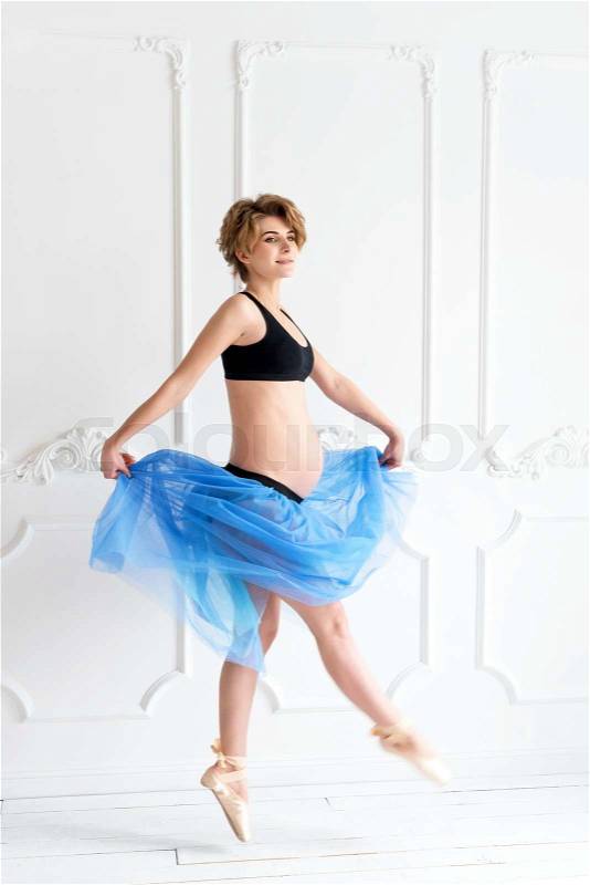 Pregnancy fitness and sport concept happy pregnant woman. Pregnant ballet dancer on white background, stock photo