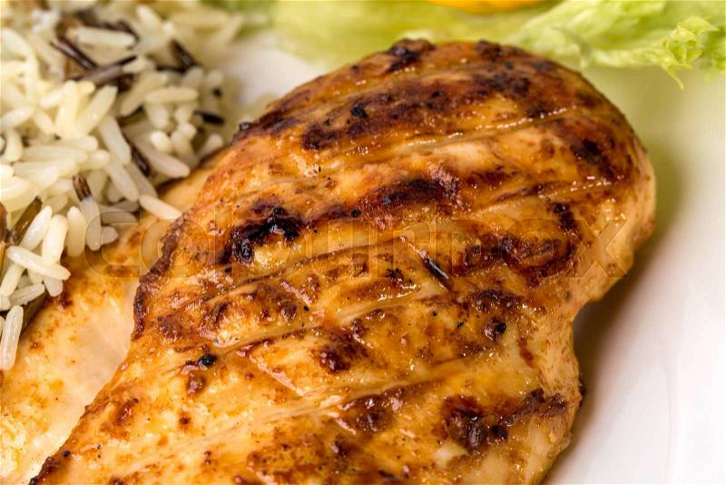 Delicious grilled chicken fillet with basmatic rice and lettuce. Macro. Photo can be used as a whole background, stock photo