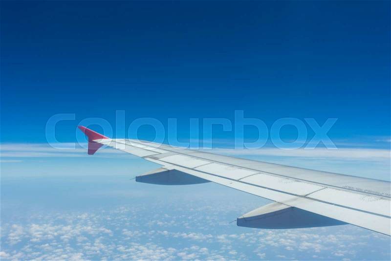 Clouds and sky as seen through window of an aircraft, stock photo