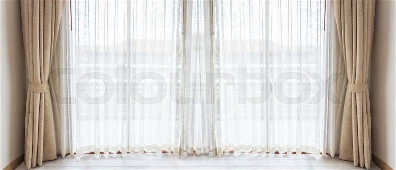 Light shines through white curtains in room, stock photo
