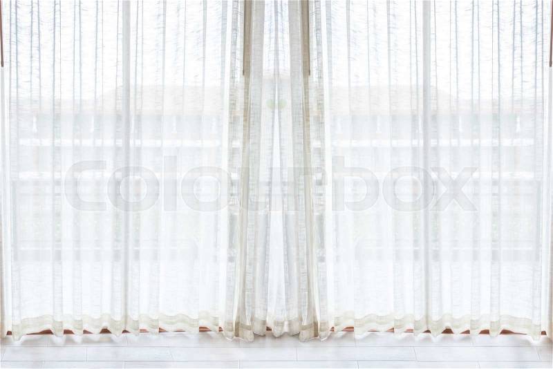Light shines through white curtains in room, stock photo