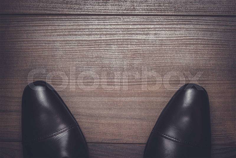 Man standing on the wooden floor background, stock photo