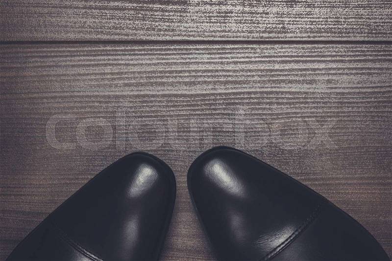 Shy man standing on the wooden floor background, stock photo