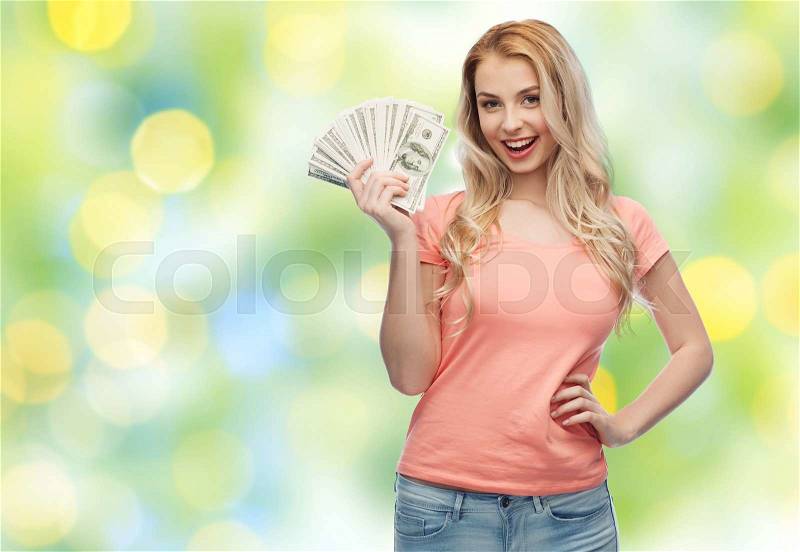 Money, finances, investment, saving and people concept - happy young woman with dollar cash money over summer green lights background, stock photo