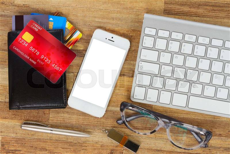 Desktop with mobile phone and wallet with plastic cards, stock photo
