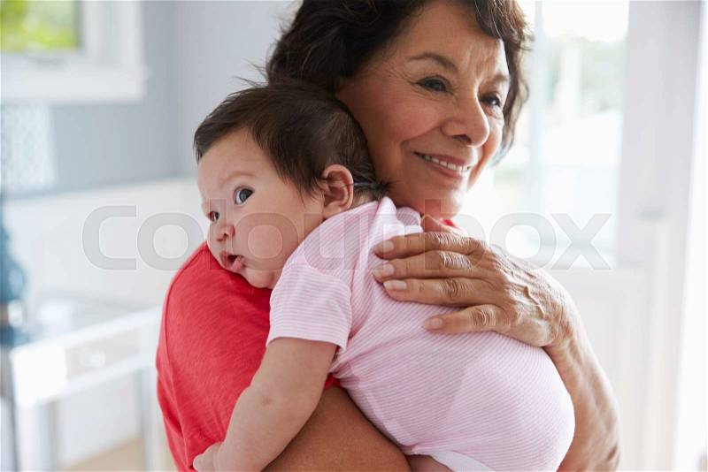 Proud Grandmother Holding Baby Granddaughter, stock photo