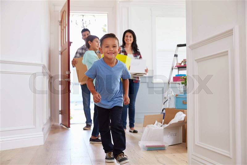 Portrait Of Hispanic Family Moving Into New Home, stock photo