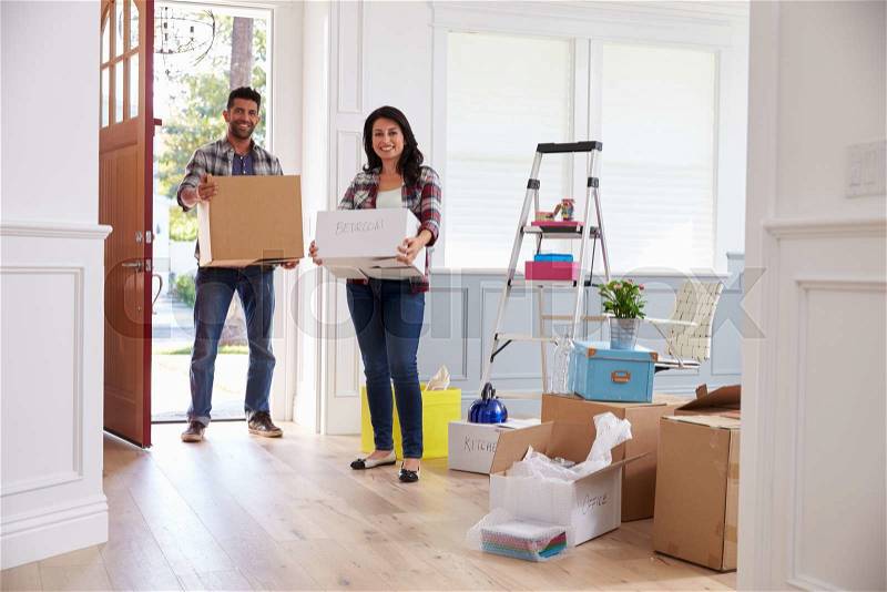 Hispanic Couple Moving Into New Home Together, stock photo