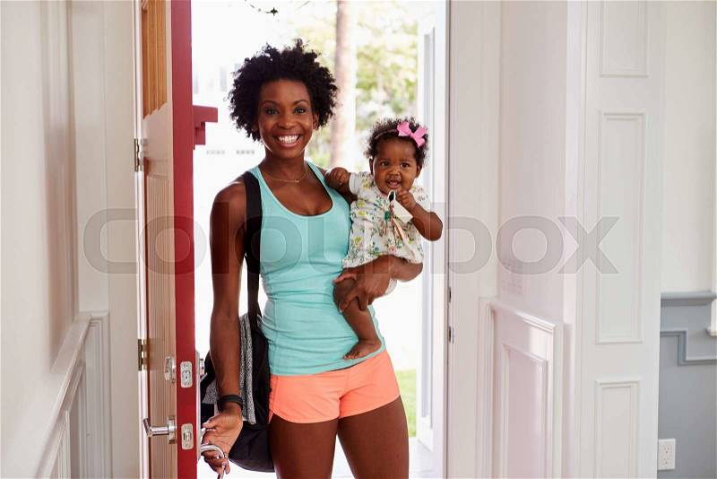 Young black woman and child arrive home after exercising, stock photo