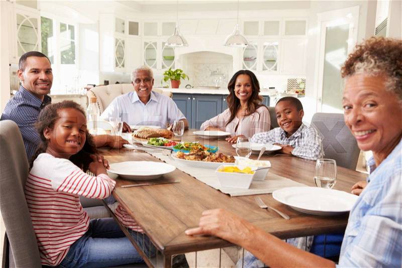 Multi generation black family at kitchen table for a meal, stock photo