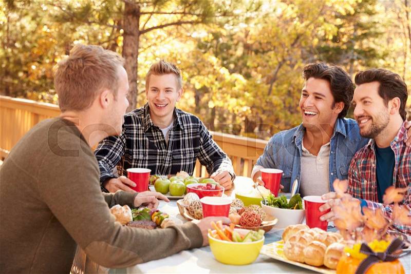 Group Of Gay Male Friends Enjoying Outdoor Meal Together, stock photo