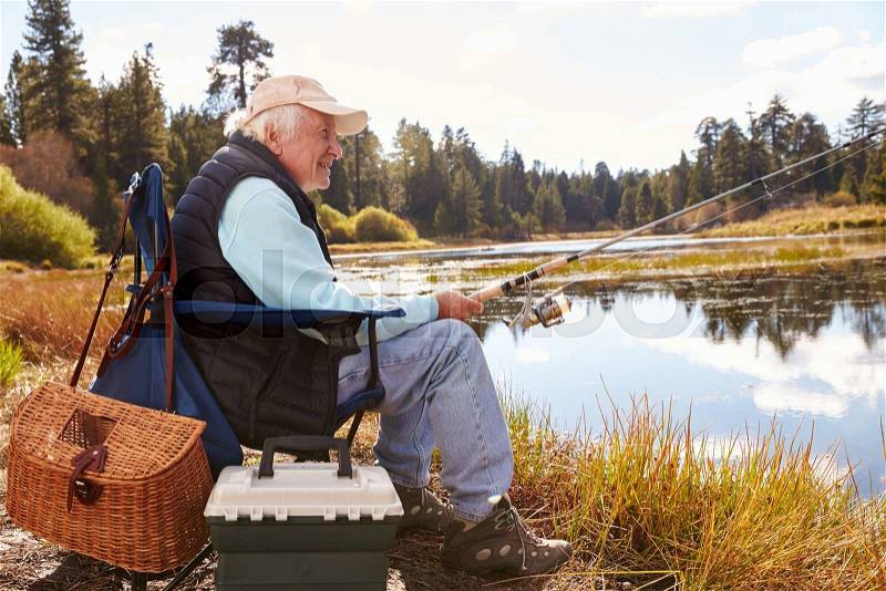 Senior man fishing in a lake, Big Bear, California, close-up, stock photo