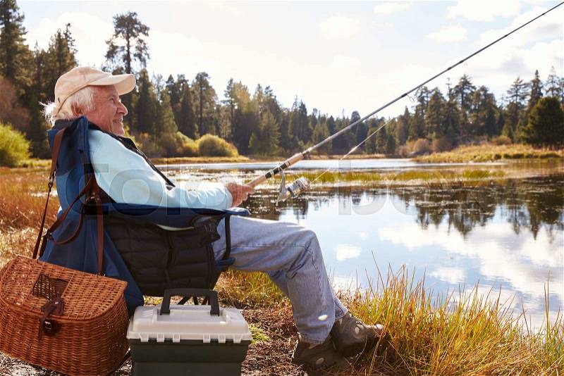 Senior man fishing in a lake, Big Bear, California, close-up, stock photo