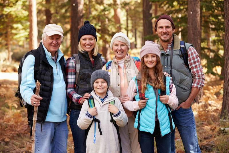 Multi generation family on hike in forest, group portrait, stock photo
