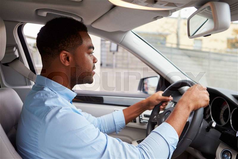 In car view of young male African American driving a car, stock photo