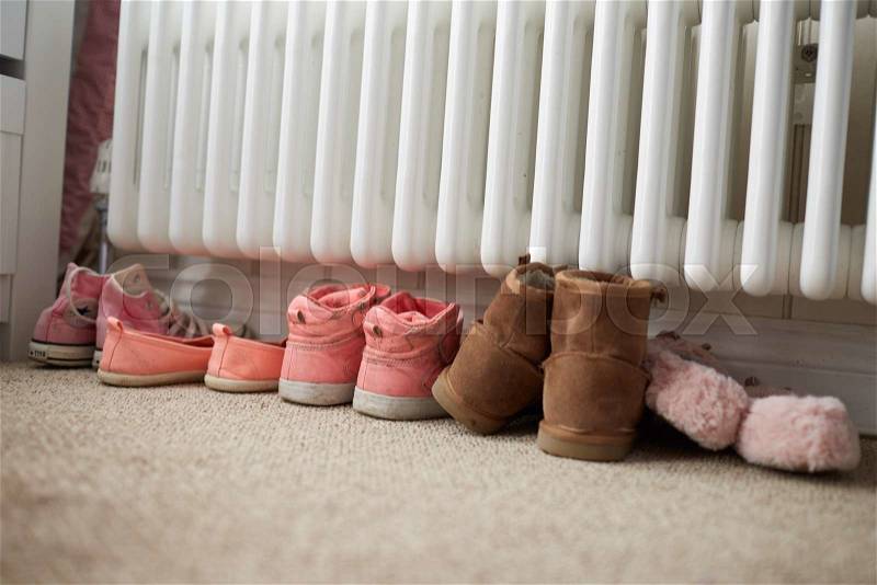 Shoes By Radiator In Family Home, stock photo